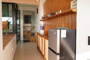 a kitchen with a refrigerator and wooden cabinets at The perch in Puerto Escondido