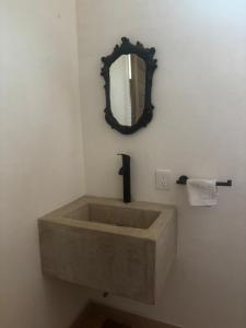 a bathroom with a large sink and a mirror at The perch in Puerto Escondido