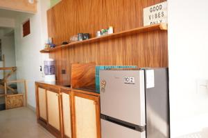 a kitchen with a refrigerator and wooden cabinets at The perch in Puerto Escondido +7 photos