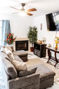a living room with a couch and a fireplace at The Huntsville Nest - 2BR Near SHSU - Pool - WiFi - Free Parking in Huntsville
