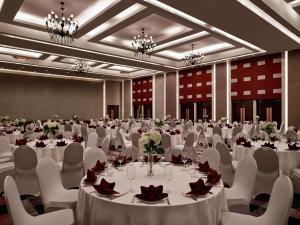 a large banquet hall with white tables and chairs at Pullman Hanoi in Hanoi +187 photos