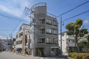 a building with a tower on the side of a street at メーイン北 in Tokyo