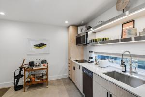 a kitchen with a sink and a counter at Hotel SOMA in Fort Worth +46 photos