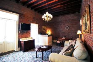 a living room with a couch and a brick wall at The Olivier House Hotel in New Orleans