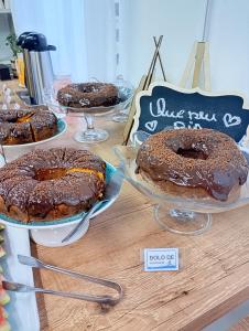 a table with three chocolate covered donuts on display at Pousada Villa do Mar in Penha