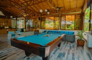 a pool room with a pool table in a house at Bungalows Punta Uva in Puerto Viejo