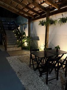 a patio with a table and a bench and stairs at Pousada Villa do Mar in Penha