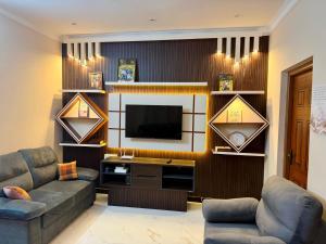 a living room with a couch and a television at Revival Villa in Coonoor