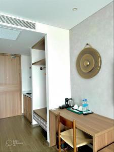 a room with a wooden table and a kitchen at Blue View Apec Tuy Hoa in Tuy Hoa