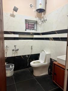 a bathroom with a toilet and a sink at Revival Villa in Coonoor