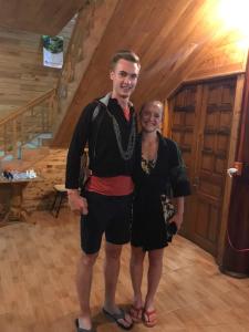 a man and woman posing for a picture in a cabin at My's Hmong House in Tả Van