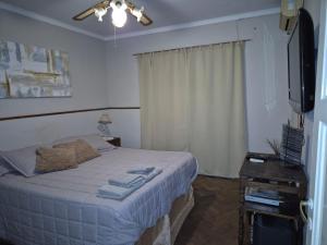 a bedroom with a bed and a flat screen tv at Lahogareña in La Cieneguita