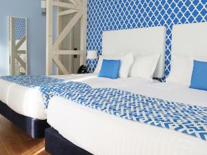 two beds in a room with blue and white at Dream Chiado Apartments in Lisbon
