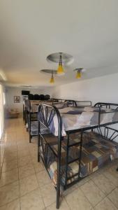 a row of bunk beds in a room at Height 909 Hostal in Juayúa