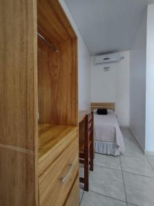 a wooden door in a room with a bed at Pousada Chale Joana in Alter do Chao