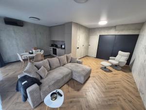 a living room with a couch and a table at Marių namai in Kaunas