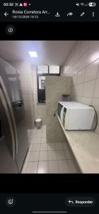 a picture of a bathroom with a microwave on a counter at Mom Blanc Flat Service in São Luís