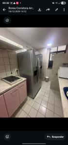 a kitchen with a stainless steel refrigerator in a room at Mom Blanc Flat Service in São Luís +11 photos