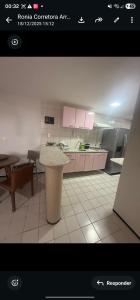 a kitchen with pink cabinets and a counter top at Mom Blanc Flat Service in São Luís