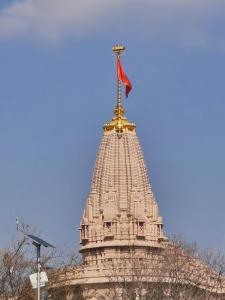 a tower with a flag on top of a building at Shri Janki Raman kunj 5 minut from ram mandir in Ayodhya