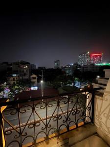 a view of a city at night from a balcony at Golden Villa in Hanoi