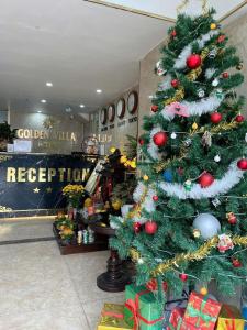 a christmas tree in a store with presents at Golden Villa in Hanoi