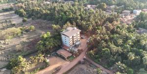 an aerial view of a building in the middle of a forest at Shrileela Beach Resort in Murūd +9 photos