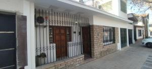 a front door of a house with a fence at Lahogareña in La Cieneguita