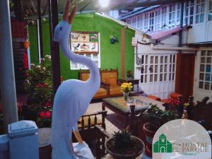 a statue of a swan standing in a room at Hostería Real Parque Tababela in Tababela