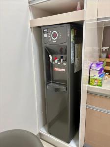 a small refrigerator in a kitchen with its door open at Ling Lai B&B in Neipu