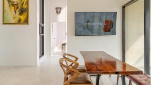 a dining room with a wooden table and a chair at Pohang Sausalito by B-Class Pool Villa in Pohang
