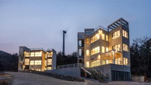 a large building with lights on in front of it at Pohang Sausalito by B-Class Pool Villa in Pohang +4 photos