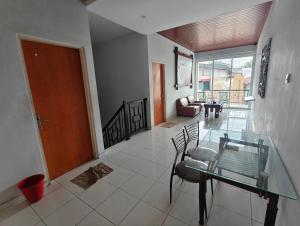 a living room with a glass table and chairs at Just Inn in Semarang