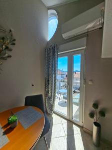 a dining room with a table and a balcony at Villa Neda in Vodice