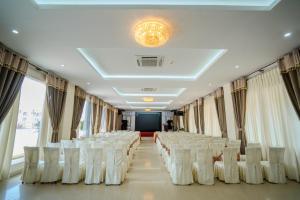 a room with rows of white chairs and a stage at Hung Long Harbour Hotel in Cat Ba +47 photos