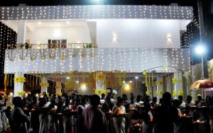 a crowd of people standing in front of a stage at Marari A R Residency in Mararikulam
