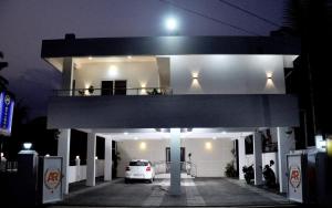 a white car parked in a garage at night at Marari A R Residency in Mararikulam +8 photos