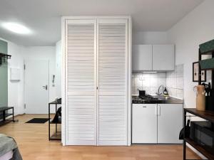 a kitchen with white cabinets and a large closet at Modern, Gemütlich mit WLAN, TV in Essen