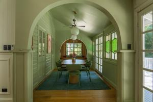 an arched hallway with a table and chairs at Vihara - Stunning, Private apartment with private pool in Mullumbimby