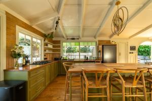 a kitchen with a large wooden table and chairs at Vihara - Stunning, Private apartment with private pool in Mullumbimby
