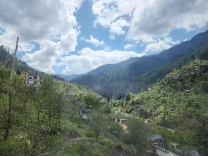 a view of a mountain with a town on a hill at Avina Heaven in Banjār