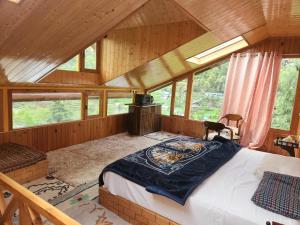 a bedroom with a large bed in a cabin at Avina Heaven in Banjār