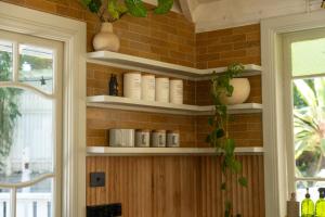 a room with shelves on a brick wall at Vihara - Stunning, Private apartment with private pool in Mullumbimby +28 photos