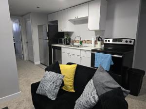 a living room with a couch in a kitchen at Basement suite in Winnipeg in Winnipeg