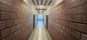 a hallway of a building with wooden walls at Tamil Arangam in Kumbakonam