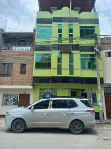 a silver van parked in front of a building at Hotel Prince in Barranca