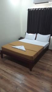 a large bed in a room with at Tamil Arangam in Kumbakonam