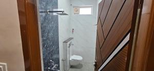 a bathroom with a shower and a toilet in it at Tamil Arangam in Kumbakonam