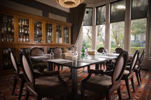 a dining room with a table and chairs and windows at One Devonshire Gardens a Hotel Du Vin in Glasgow +72 photos