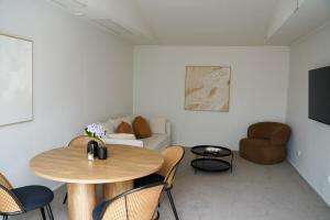 a living room with a table and a couch at Mapua Village Modern Studio in Mapua